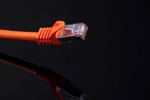 Orange data cable for fast internet on black background for a modern home ins Stock Photos