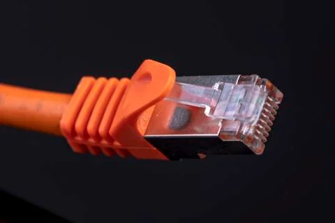 Orange data cable for fast internet on black background for a modern home ins Stock Photos