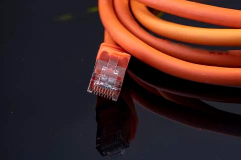 Orange data cable for fast internet on black background for a modern home ins Stock Photos