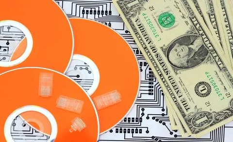 Orange Data saving concept; dvd, jacks, paper money and circuit board. Cop... Stock Photos
