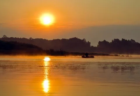 Orange dawn on the river Stock Photos