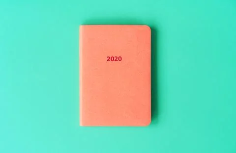 Orange diary for 2020 on a mint background. New Year concept in trendy colors. Stock Photos