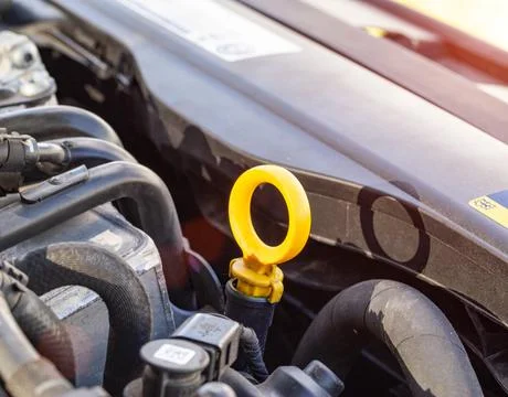 Orange dipstick for checking the oil level in a diesel engine. Concept of oil Foto stock