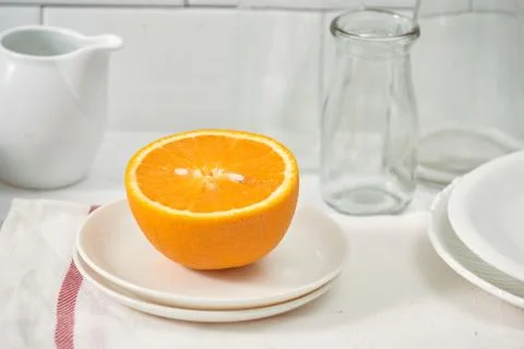 Orange in a dish on the table in the kitchen Stock Photos