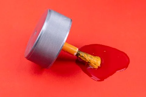 Orange do-it-yourself paint with brush and red background Stock Photos
