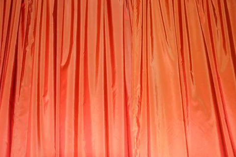 Orange draped curtains close up texture for textile background Stock Photos