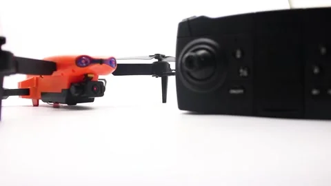 Orange drone with camera and remote control Stock Footage 247428826