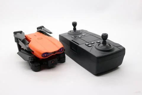 Orange drone with camera and remote control Stock Photos