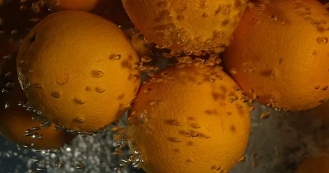 Orange Drops Under Water on Black Background. Fresh Orange Fruit Plunging And Stock Footage 96545311