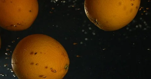 Orange Drops Under Water on Black Background. Fresh Orange Fruit Plunging And Stock-Footage 96545349
