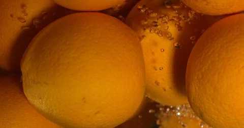 Orange Drops Under Water on Black Background. Fresh Orange Fruit Plunging And Stock Footage 96545451