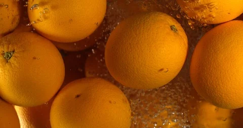 Orange Drops Under Water on Black Background. Fresh Orange Fruit Plunging And Stock-Footage 96545474