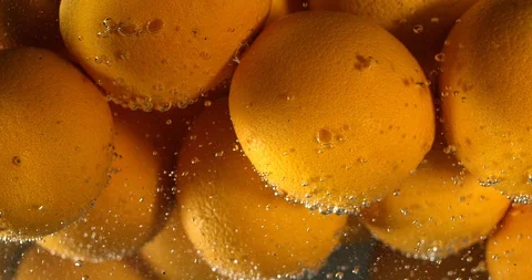 Orange Drops Under Water on Black Background. Fresh Orange Fruit Plunging And Stock Footage 96545477