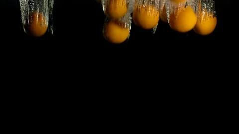 Orange Drops Under Water on Black Background. Fresh Orange Fruit Plunging And Stock Footage 96546644