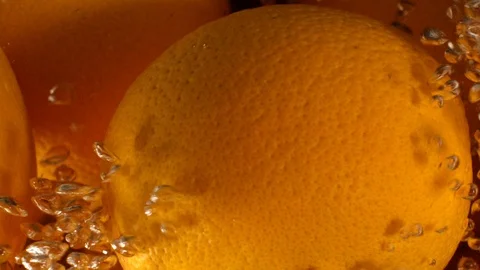 Orange Drops Under Water on Black Background. Fresh Orange Fruit Plunging And Stockbeeldmateriaal 96546648