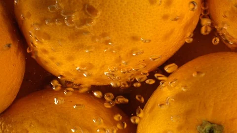 Orange Drops Under Water on Black Background. Fresh Orange Fruit Plunging And Stock Footage 96546678