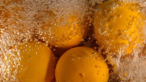 Orange Drops Under Water on Black Background. Fresh Orange Fruit Plunging And Stock-Footage 96546700