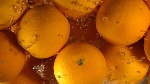 Orange Drops Under Water on Black Background. Fresh Orange Fruit Plunging And Stock Footage 96546704