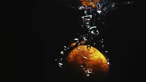 Orange Drops in Water Creating Splash Stock Footage 300892486