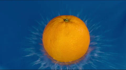 Orange drops on a wet blue table Stock Footage 48010751