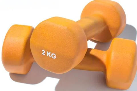Orange dumbbell on white background close up Фото