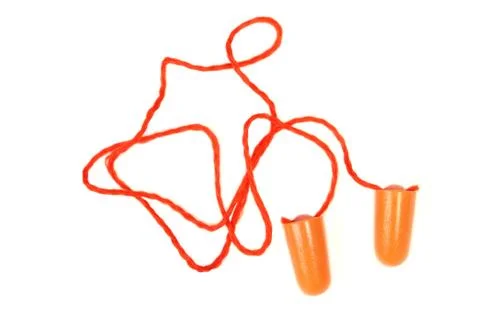 Orange earplug for work. Earplug to reduce noise on a white background . Stock Photos