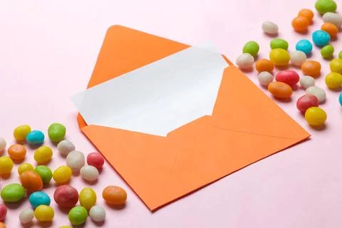Orange envelope with a blank for text and colorful panting on a bright trendy Stock Photos