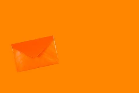 An orange envelope on an orange background Foto stock