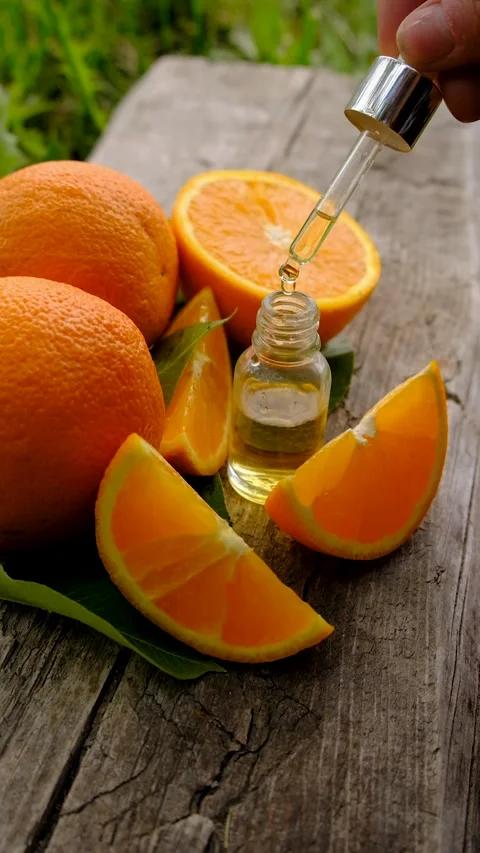 Orange essential oil in a bottle. Selective focus. Stock Footage 312626786