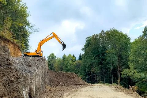 Orange excavator in the process Stock Photos