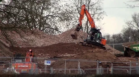 Orange Excavators Digging and Driving Over a Hill Vídeos de archivo 35677364