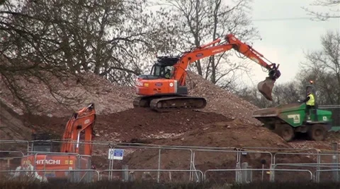 Orange Excavators Driving Down a Hill and Digging Up Earth Vídeos de archivo 35676964