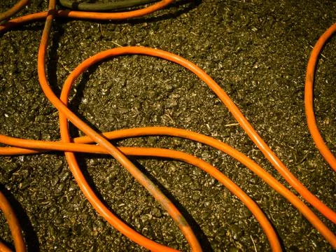 The Orange Extension Cord on the Ground at the Construction Site Stock Photos