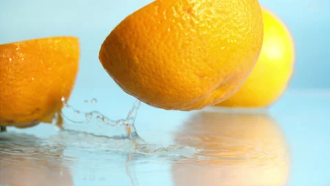 Orange fall into the water on  background Super slow-mo 1000 fps Stock Footage 163960652