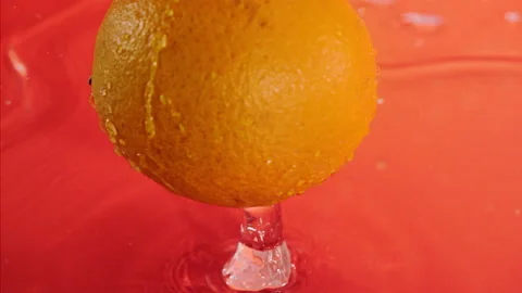 Orange fall into the water on  background Super slow-mo 1000 fps Stock Footage 163962087