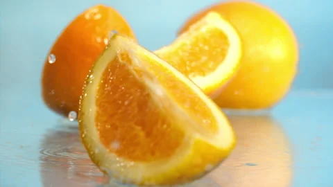 Orange fall into the water on blue background Super slow-mo 1000 fps Stock Footage 281564316