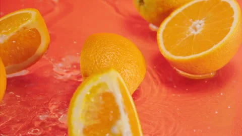 Orange fall into the water on orange background Super slow-mo 1000 fps Stock Footage 276732046