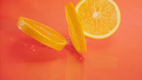 Orange fall into the water on orange background Super slow-mo 1000 fps Stock Footage 276732120
