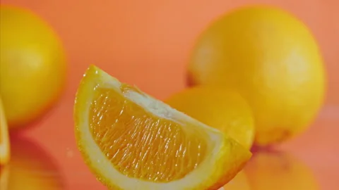 Orange fall into the water on orange background Super slow-mo 1000 fps Stock Footage 281564324