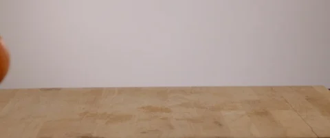 Orange Falling On To Cutting Board And Then Rolling Off In Slow Motion 動画素材 105371839