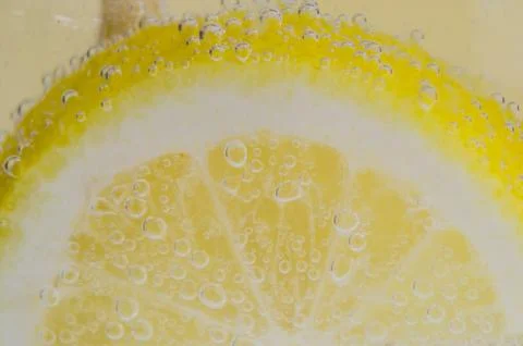 An orange falling into the water. Bright background Stock Photos