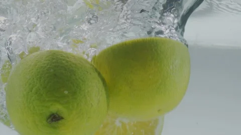 Orange falling in water Stock Footage 98300497