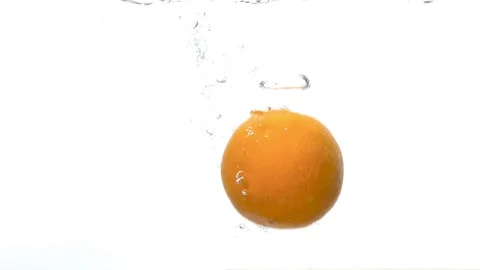 Orange falling into the water Stock Footage 123692646