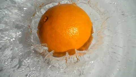 Orange falling into the water. Slow motion. Stock Footage 128082102