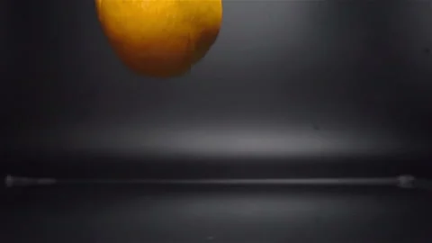 Orange Falling in Water with Splash in Slow Motion Stock Footage 104725841