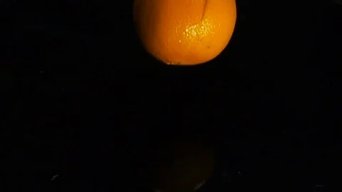The orange falls into the water, slow motion Stock Footage 84912657