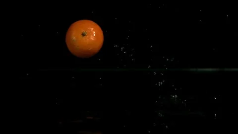 Orange falls into water with a splash Stock Footage 326755981