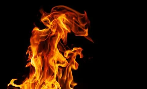 Orange fire flames on a black background Stock Photos