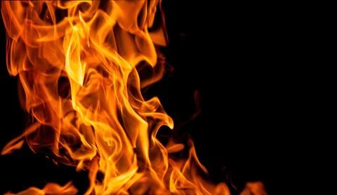 Orange fire flames on a black background Stock Photos