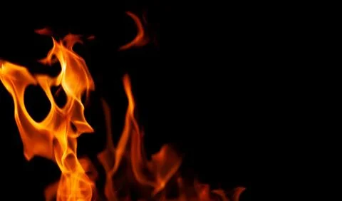 Orange fire flames on a black background Stock Photos